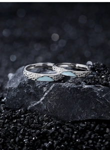 Detailed view of sterling silver mountain rings with blue texture on rocky surface