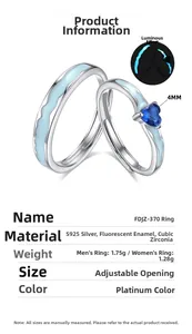 Macro detail of S925 silver couple rings featuring heart-shaped blue zircon and glowing effect