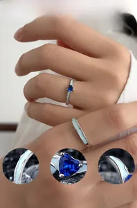 Close-up of S925 silver rings featuring blue heart cubic zirconia and enamel wave texture