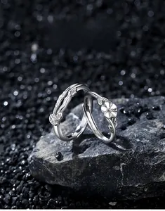 Macro shot of 925 sterling silver camellia flower couple rings with adjustable opening