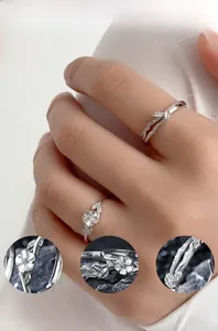 Macro details of polished 925 sterling silver couple rings with camellia flower design