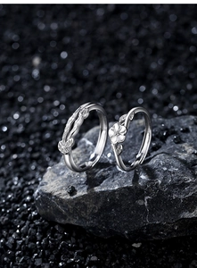 Detail of floral and bark texture on S925 sterling silver couple rings on stone