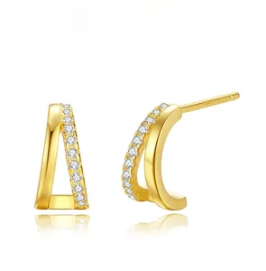 Macro detail of double hoop 925 silver earrings with gold plating and sparkling zircon