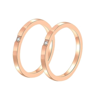 Elegant rose gold stainless steel rings with single diamond accent, minimalist style