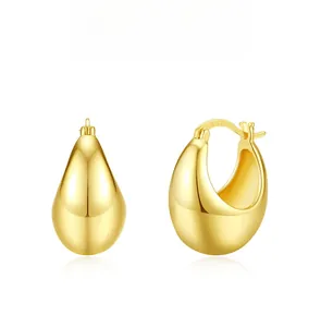 Detailed macro view of S925 hallmark on polished gold-plated teardrop earrings