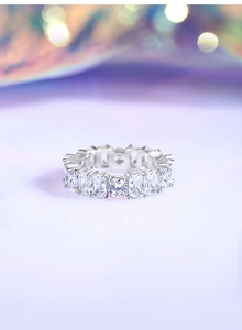Detailed view of S925 silver eternity band with emerald and round cut cubic zirconia
