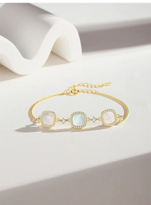 Detailed view of S925 silver gold bracelet featuring square white shell charms and zircons
