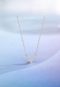Close-up of s925 silver V-shaped heart pendant necklace with shimmering pave diamonds