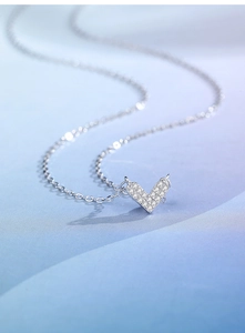 Macro shot of V-shaped heart pendant with pave cubic zirconia on a silver S925 chain