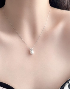 Close-up of a 925 sterling silver necklace with large freshwater pearl and marquise pendant