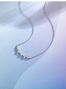 Detailed view of s925 silver curved pendant necklace with sparkling cubic zirconia stones