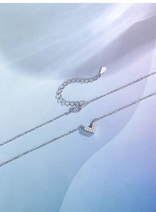 Macro shot of S925 sterling silver heart necklace with sparkling pavé zircons