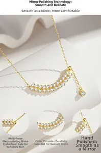 Detail of gold wheat ear necklace with cubic zirconia tassels and polished finish