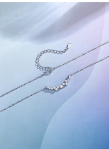 Detailed view of S925 sterling silver smile necklace with sparkling curved crystals