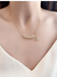 Detail of S925 silver wheat ear necklace with zircons worn on model's neck