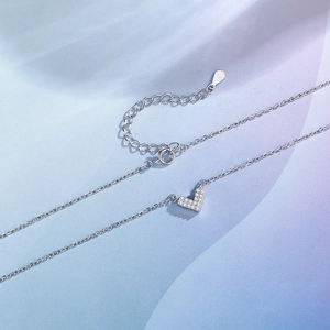 Elegant S925 sterling silver V-shaped heart necklace with cubic zirconia on blue background