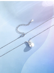 Detailed view of S925 silver necklace with a large freshwater pearl and marquise stone pendant