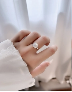 Close-up of S925 silver moissanite halo ring with micro-pave diamonds on model hand