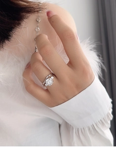 Macro shot of S925 silver bridal ring set with sparkling round cut moissanite on a hand