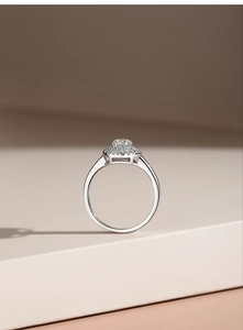 Detail view of double halo moissanite ring on geometric display stand with fine silver band