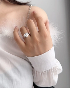 Close-up of elegant S925 silver bridal ring with oval diamond on a model hand