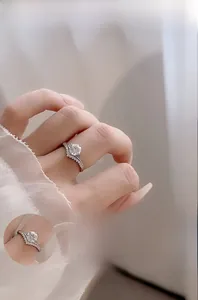 Detail view of V-shaped 925 silver ring with Moissanite stone and crown pavé setting