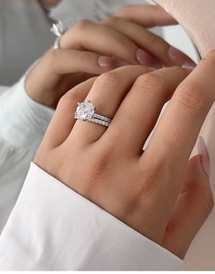 Close-up of S925 silver bridal ring set with a six-prong round cut sparkling stone
