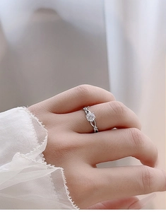 Detailed side view of S925 silver moissanite ring with twisted band and lace sleeve detail