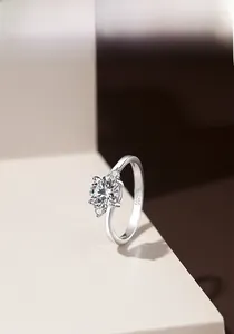 Detailed close-up showing S925 sterling silver stamp and three-stone round moissanite setting