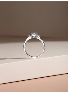 Macro shot of S925 sterling silver three-stone ring with round moissanite in four-prong setting