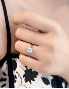 Close-up of S925 sterling silver halo ring with round moissanite on a model finger