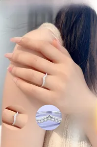 Close-up of S925 sterling silver V-shaped ring with zircon stones on a model's hand
