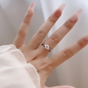 Three-stone S925 sterling silver ring with one-carat round moissanite on model hand