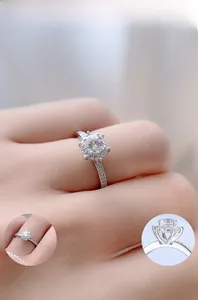 Detailed view of S925 silver six-prong crown ring with moissanite and side stones