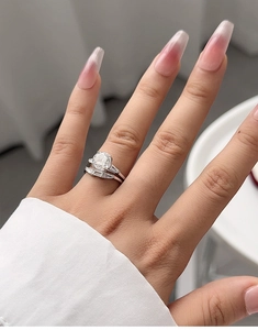 Close-up of S925 silver bridal ring set with a round solitaire and tapered baguette stones