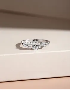 Detailed macro view of S925 silver ring featuring a large oval zircon on a beige stand