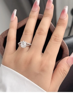 Close-up of S925 silver bridal ring featuring a large oval diamond worn on a finger