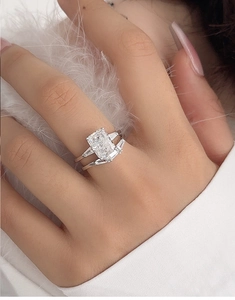 Close-up of elegant S925 silver bridal ring set with radiant cut stone on model hand