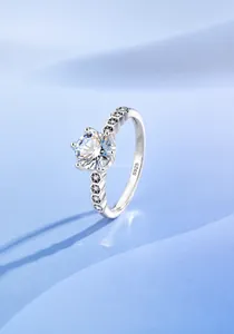 Detail of S925 silver ring featuring hexagonal honeycomb design and sparkling round cut moissanite
