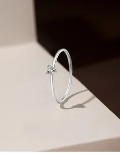 Macro shot of S925 sterling silver stamp and heart-cut cubic zirconia on a 1mm thin ring