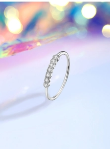 Detail shot of slim S925 sterling silver ring featuring seven sparkling round zircons