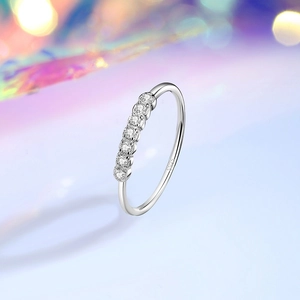 Minimalist S925 sterling silver ring with six sparkling zircons on a purple background