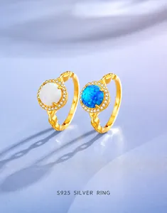 Detailed close-up of blue and white opal rings in S925 silver with zircon accents