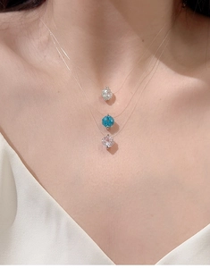 Close-up of S925 silver aquamarine pendants on minimalist transparent fishing line