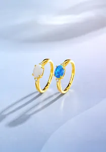 Details goldener Ringe aus 925er Silber mit ovalen weißen und blauen Opalen und Diamanten
