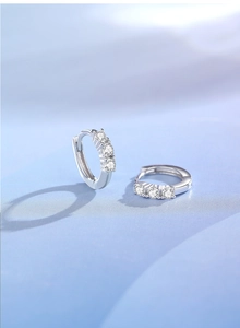 Macro view of S925 silver hoop earrings with three inlaid sparkling zircon stones
