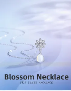 Close-up of S925 silver daisy pendant with teardrop moonstone and pavé crystals