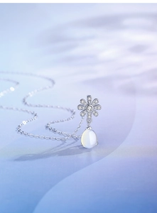 Detailed view of S925 silver daisy pendant with teardrop moonstone and pavé crystals