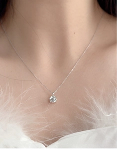 Close-up of S925 silver necklace featuring a brilliant round D color moissanite pendant