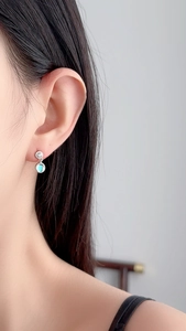 Close-up of S925 sterling silver earrings with round blue moonstone and zircon accents